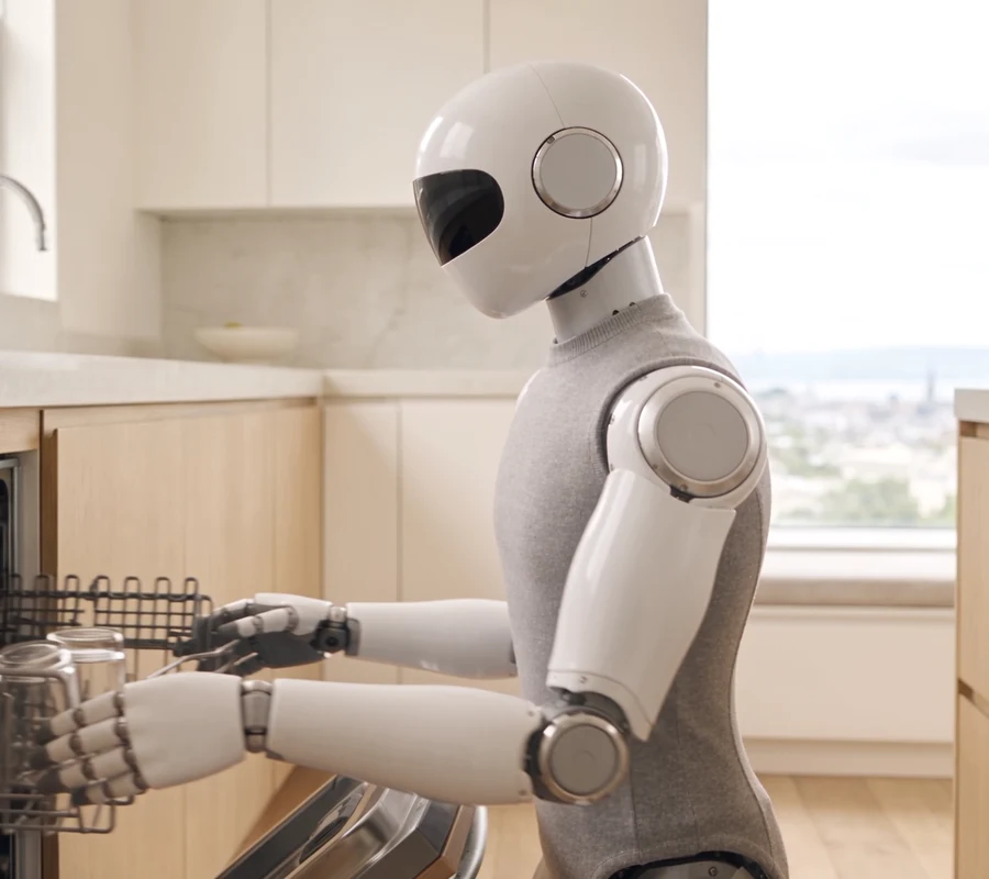 A humanoid robot loads a dishwasher, from the film on page 3