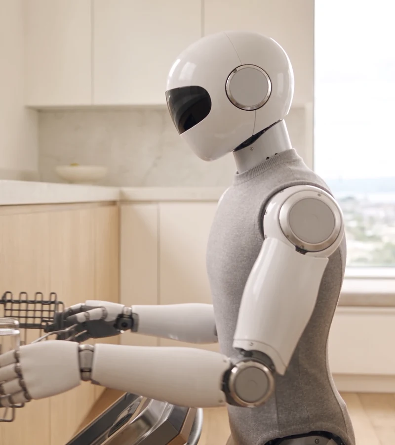A humanoid robot loads a dishwasher, from the film on page 3